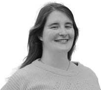 Bold image of pool lift expert adviser Katerina Antoniadou. She has long hair and is smiling at the camera, wearing a knitted jumper.